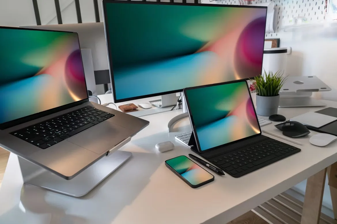 Laptop, desktop monitor, tablet and smartphone displaying the same colorful wallpaper